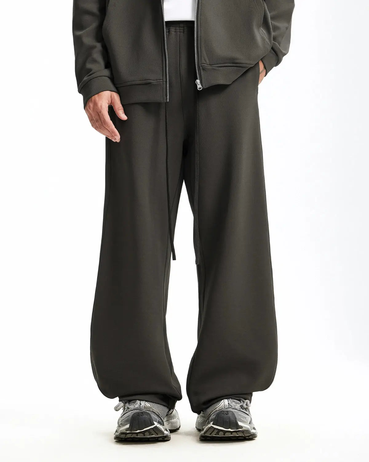 Grey baggy sweatpants by INFLATION with relaxed fit and comfortable fabric, shown laid flat on a white background.
