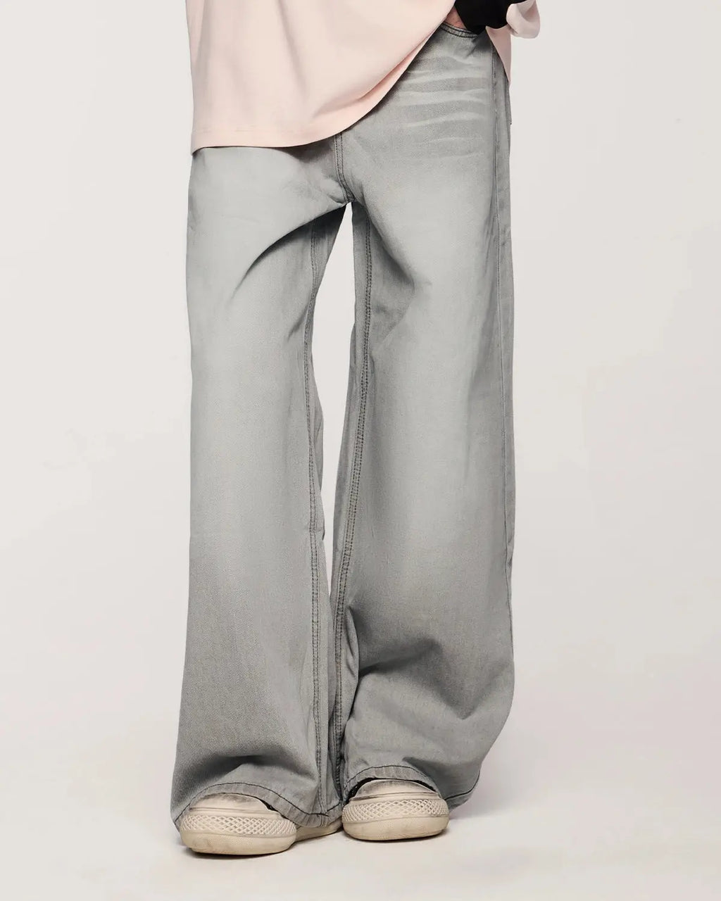 Washed distressed baggy jeans by Inflation Streetwear featuring a relaxed fit, ripped details, and faded denim texture.