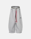 Baggy wide-leg sweatpants with waistband from INFLATION streetwear, showing relaxed fit and comfortable fabric in a casual setting.