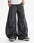 Washed curved seam cargo pants by INFLATION featuring a relaxed fit, multiple pockets, and distressed denim texture.