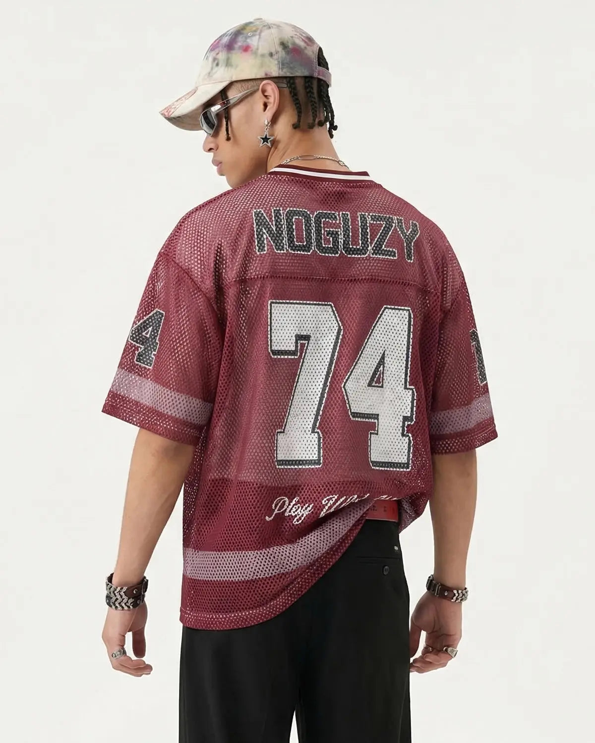 V-neck graphic mesh jersey by INFLATION, featuring bold streetwear design and breathable mesh fabric under bright lighting.