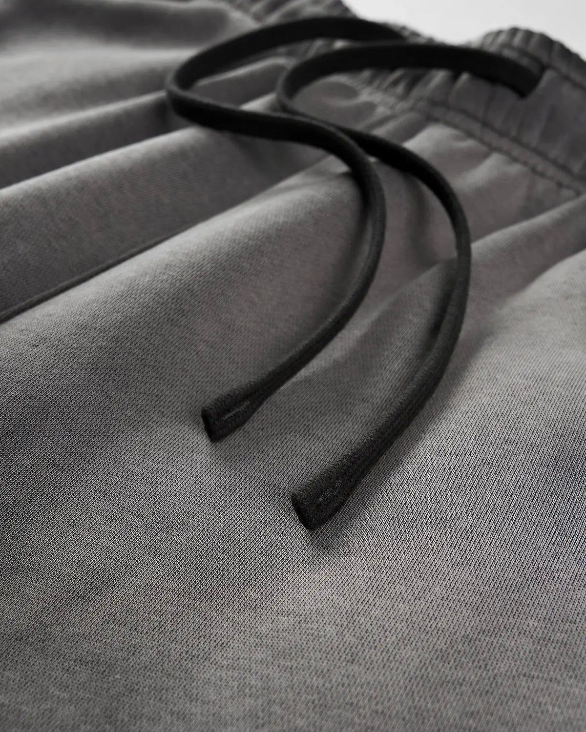 Acid washed INFLATION streetwear sweatpants with a relaxed fit and distressed denim-like texture.
