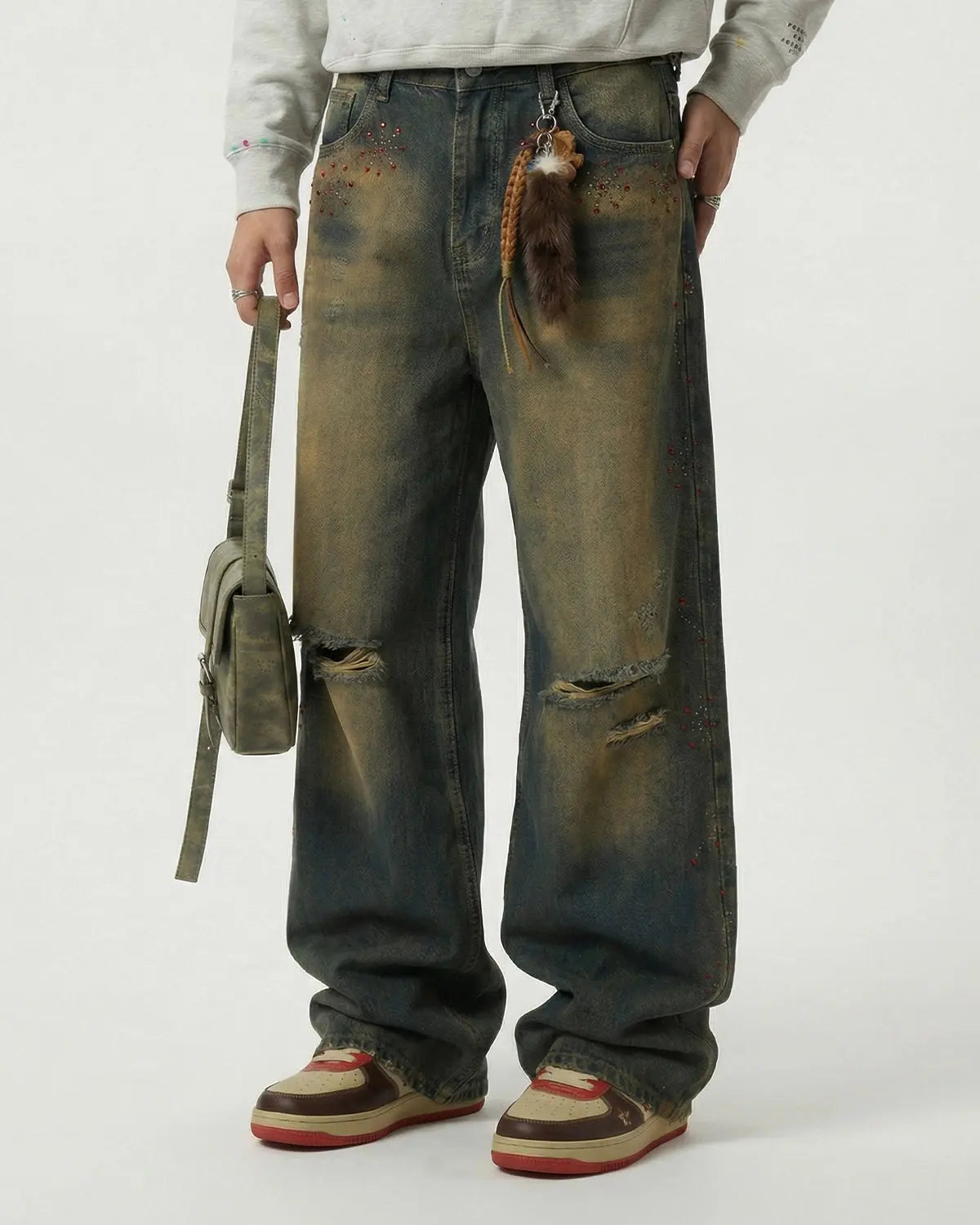 Dirty Wash Rhinestone Baggy Jeans by INFLATION featuring distressed denim, rhinestone details, and a loose, relaxed fit.