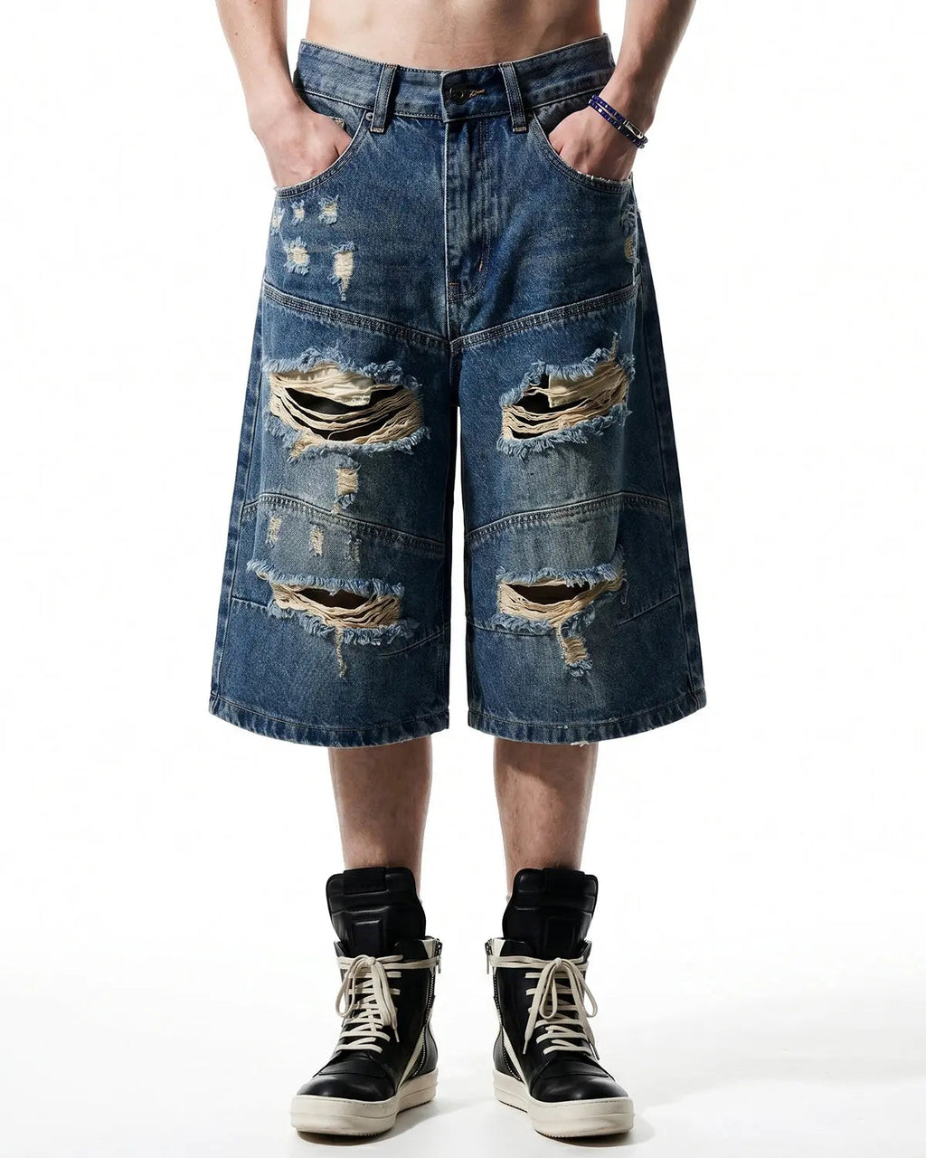 Heavy washed distressed baggy jorts by INFLATION, denim pants with a relaxed fit and rugged, worn-in style.