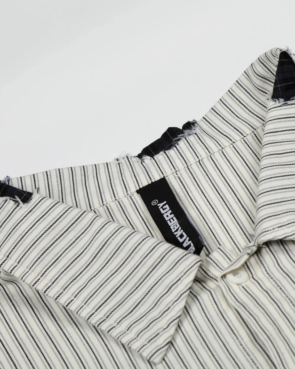 Inflation Streetwear graffiti patch striped shirt featuring bold colors and urban design, displayed on a hanger.