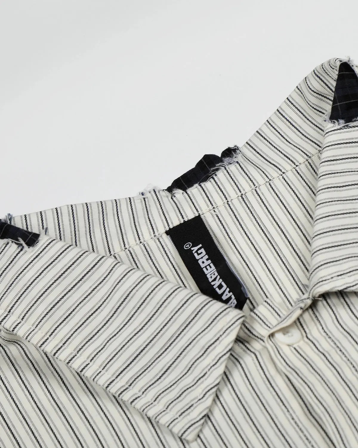 Inflation Streetwear graffiti patch striped shirt featuring bold colors and urban design, displayed on a hanger.