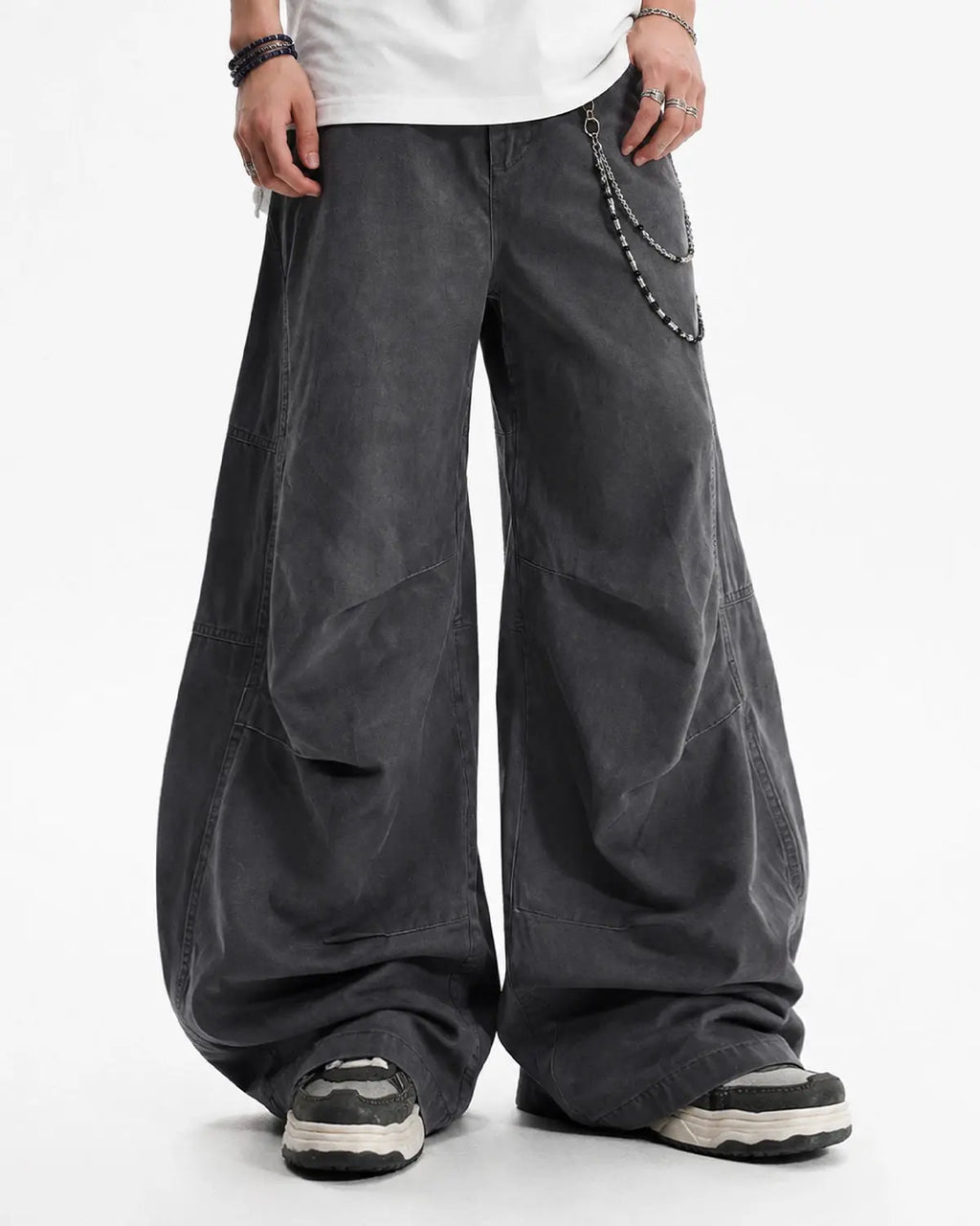 Washed curved seam cargo pants by INFLATION, streetwear style with distinctive stitching and relaxed fit in the image.