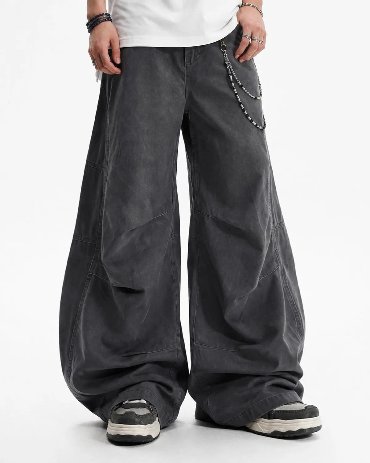 Washed curved seam cargo pants by INFLATION, streetwear style with distinctive stitching and relaxed fit in the image.