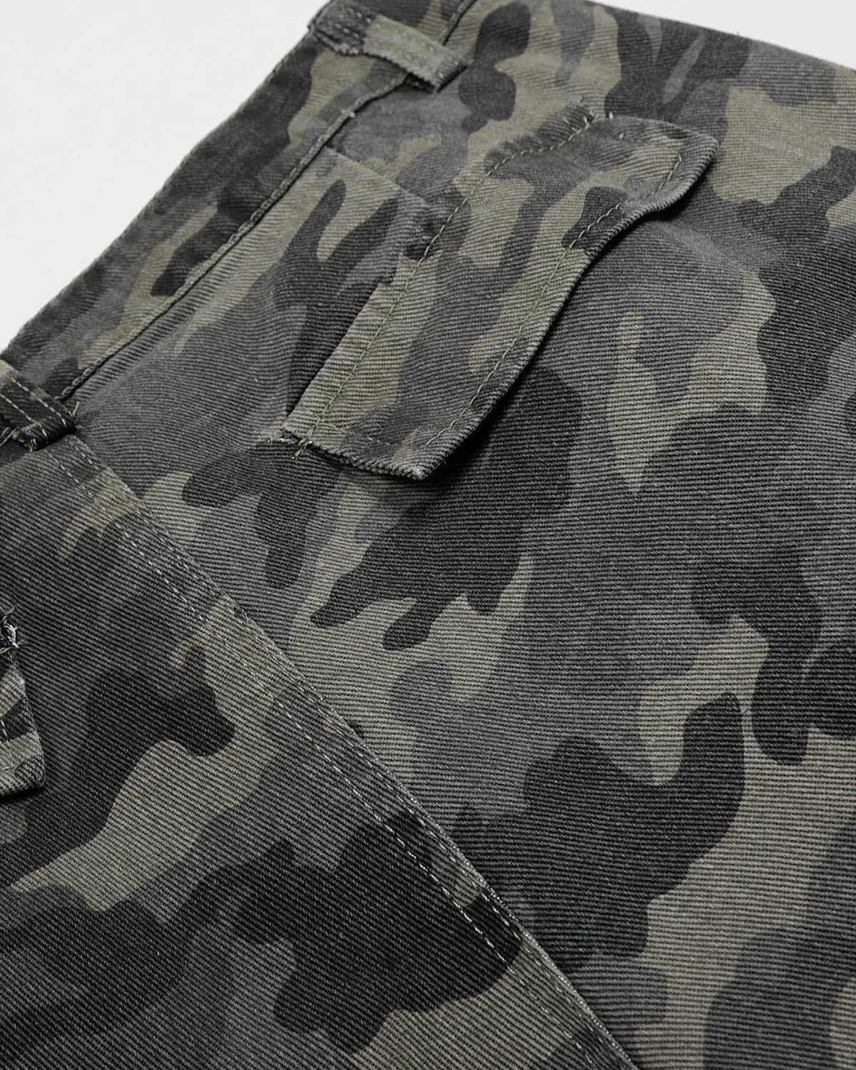 Embroidered camo cargo pants by INFLATION featuring multiple pockets and streetwear style, casual fit with camouflage pattern.