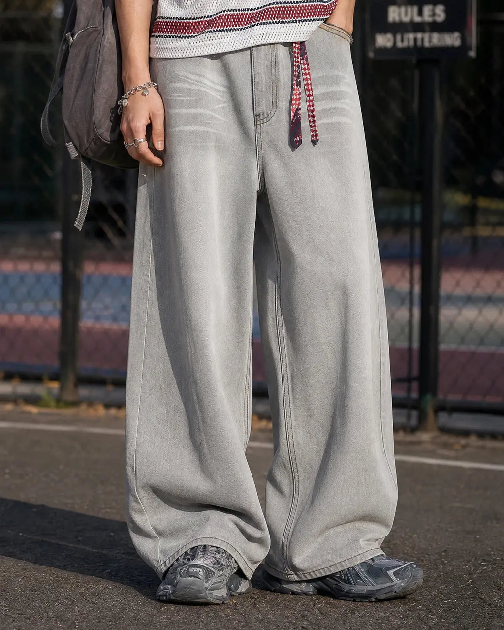 Washed distressed baggy jeans from Inflation Streetwear with ripped details and relaxed fit, shown on a model.