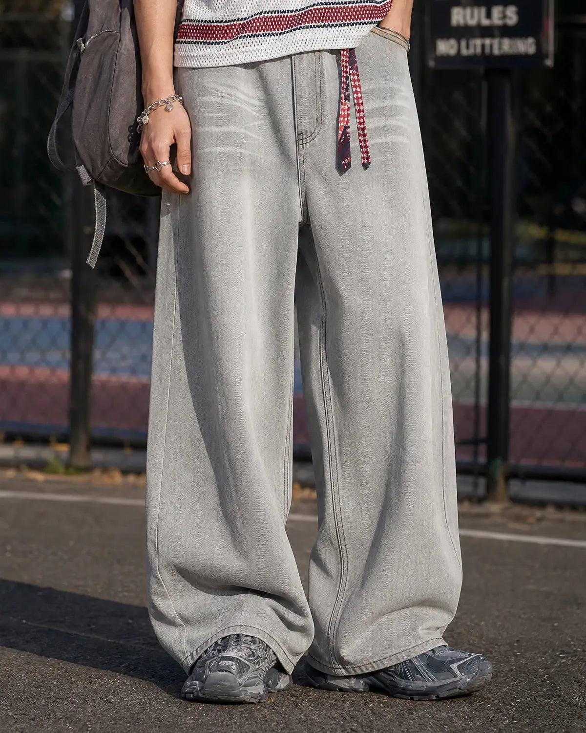 Washed distressed baggy jeans from Inflation Streetwear with ripped details and relaxed fit, shown on a model.