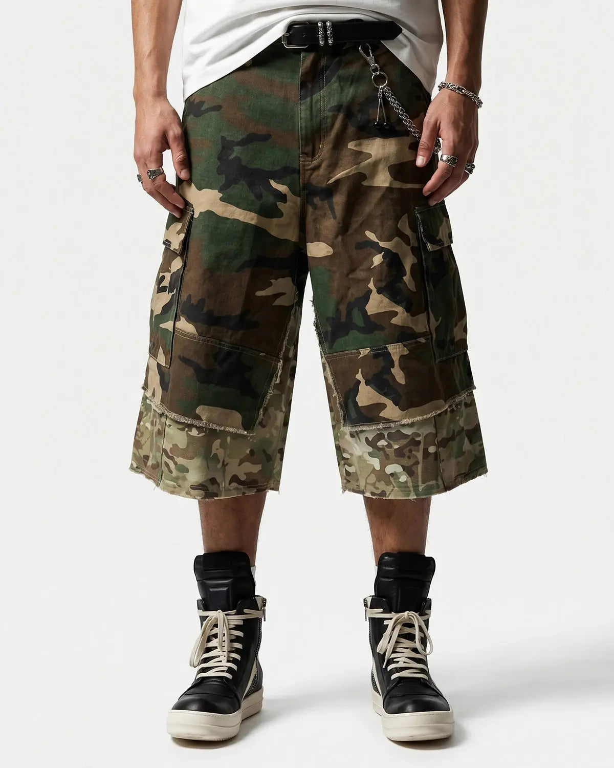 Camo layered longline jorts from INFLATION streetwear, featuring a relaxed fit and layered design with camouflage fabric detail.