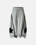 Contrast patchwork barrel sweatpants by INFLATION Streetwear featuring bold color blocks and relaxed fit, shown on a mannequin.
