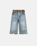 Leopard patchwork jorts by INFLATION, stylish denim pants with bold leopard print patchwork detail and frayed hem.