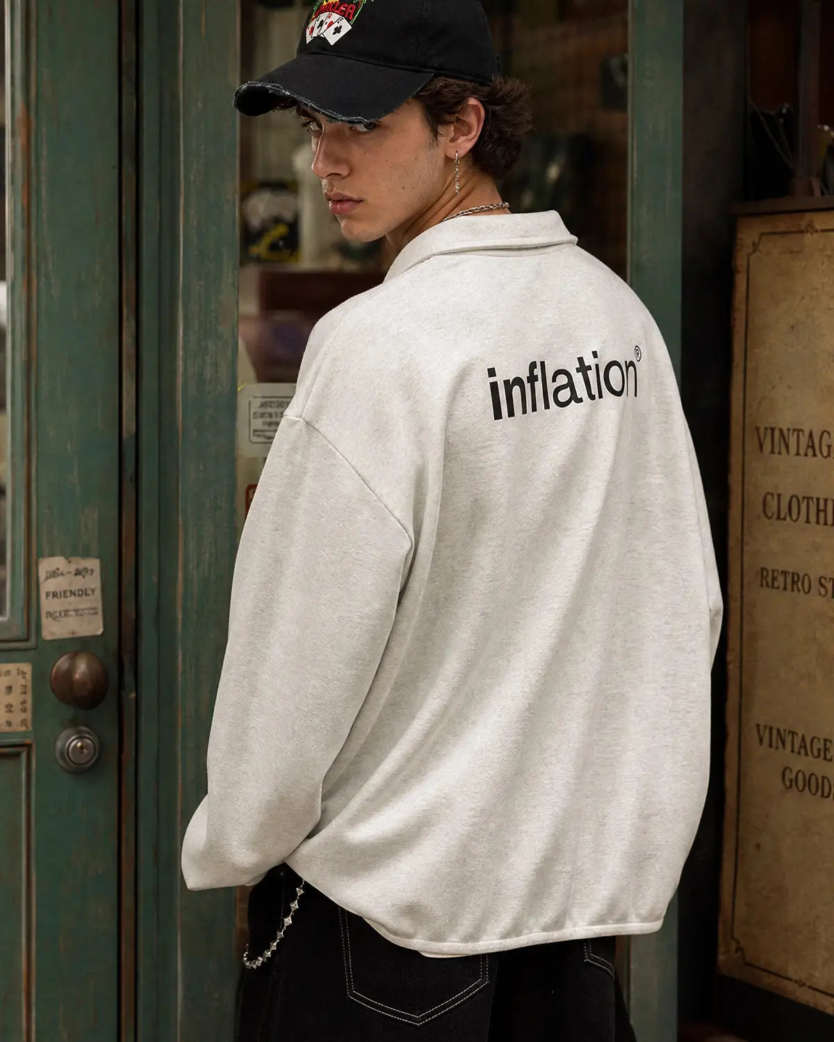 Inflation Brand Quarter Polo Sweatshirt in black with ribbed collar and cuffs, casual streetwear style.