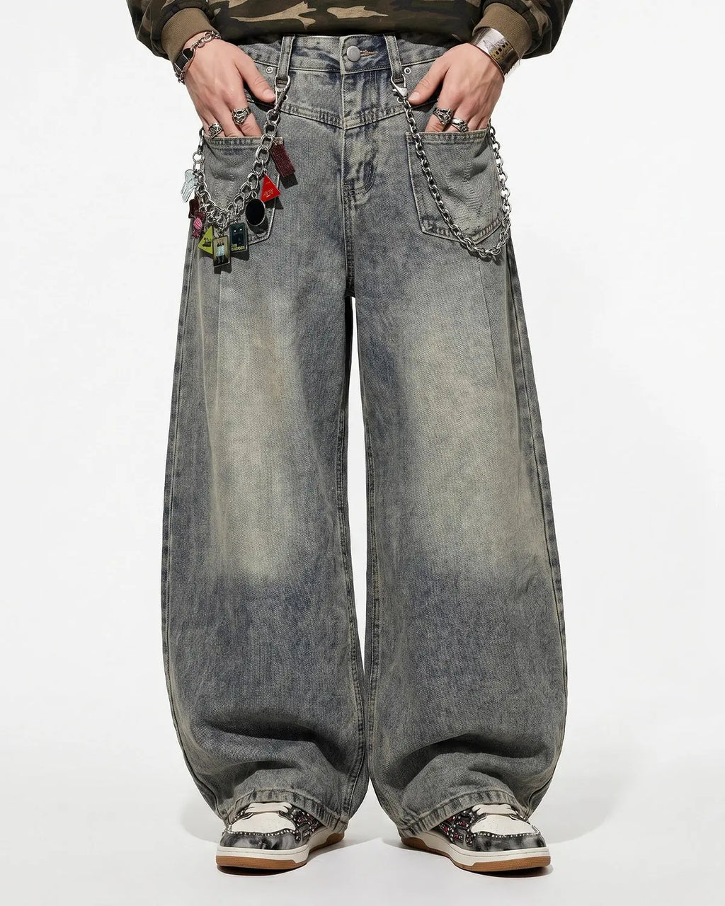 Distressed eyelet barrel jeans by INFLATION featuring ripped details, eyelet accents, and a relaxed fit for streetwear style.