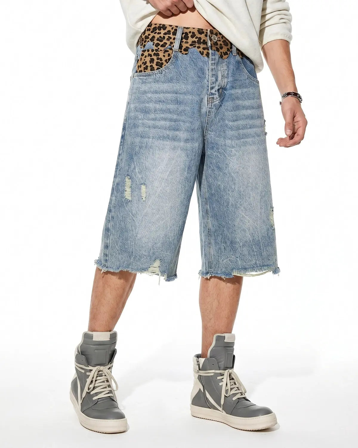 Inflation streetwear leopard patchwork jorts, denim pants with bold leopard print and patchwork design, front view.