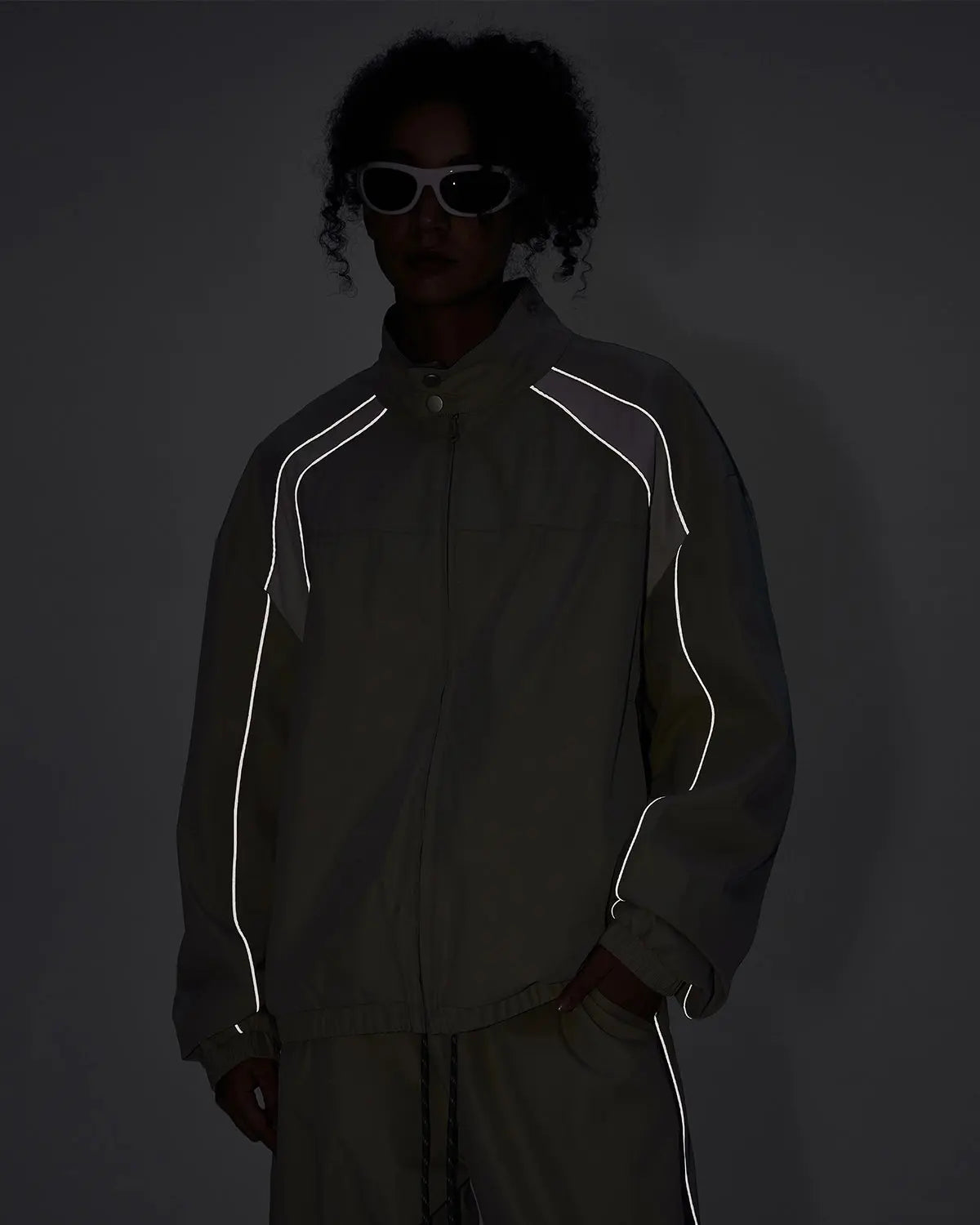 Inflation Reflective Windbreaker Track Jacket with lightweight fabric, reflective details, and sporty streetwear style.