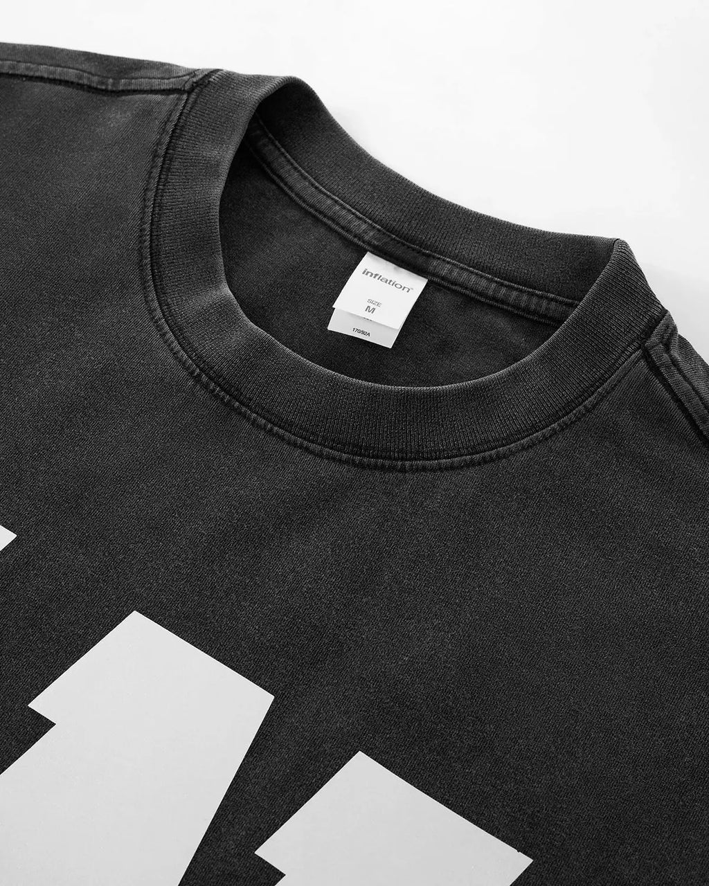Inflation Streetwear Reflective Logo Acid Wash T-shirt featuring a reflective logo design on the front, casual streetwear look.