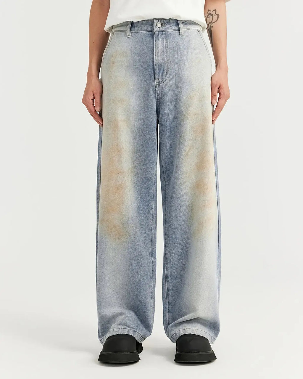 Inflation streetwear Mud Washed Baggy Jeans featuring a relaxed fit, distressed denim look, and fading details on a casual model.