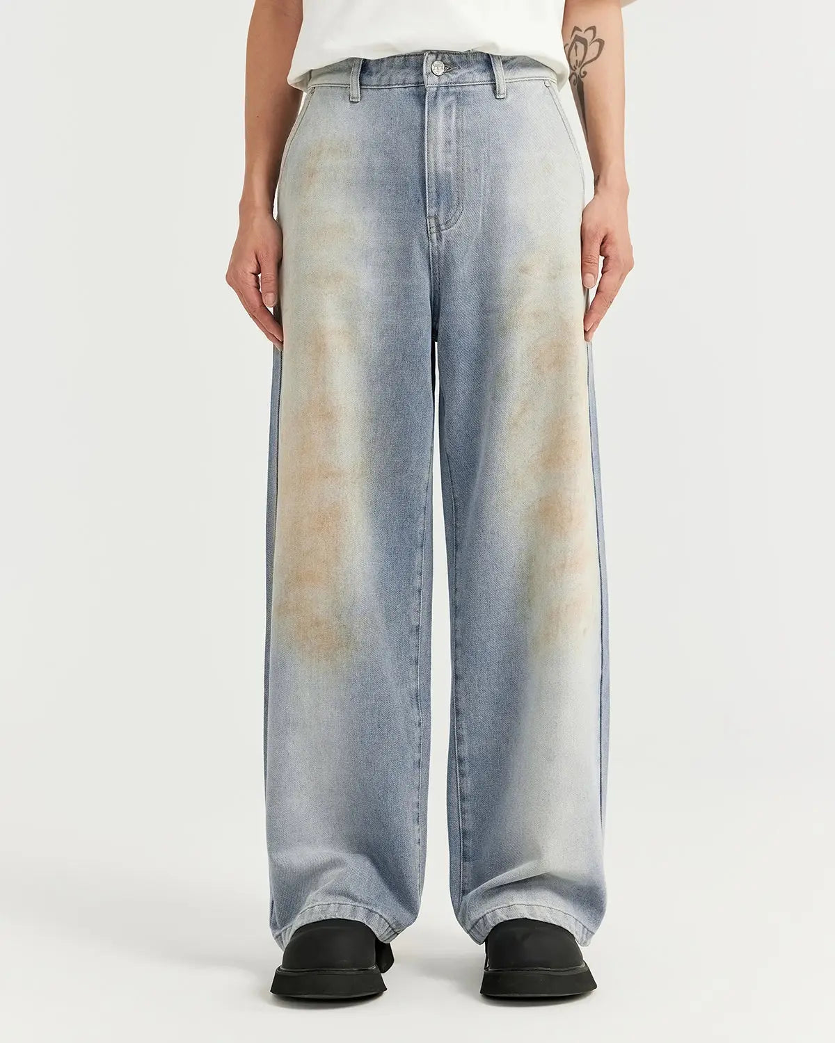 Inflation streetwear Mud Washed Baggy Jeans featuring a relaxed fit, distressed denim look, and fading details on a casual model.