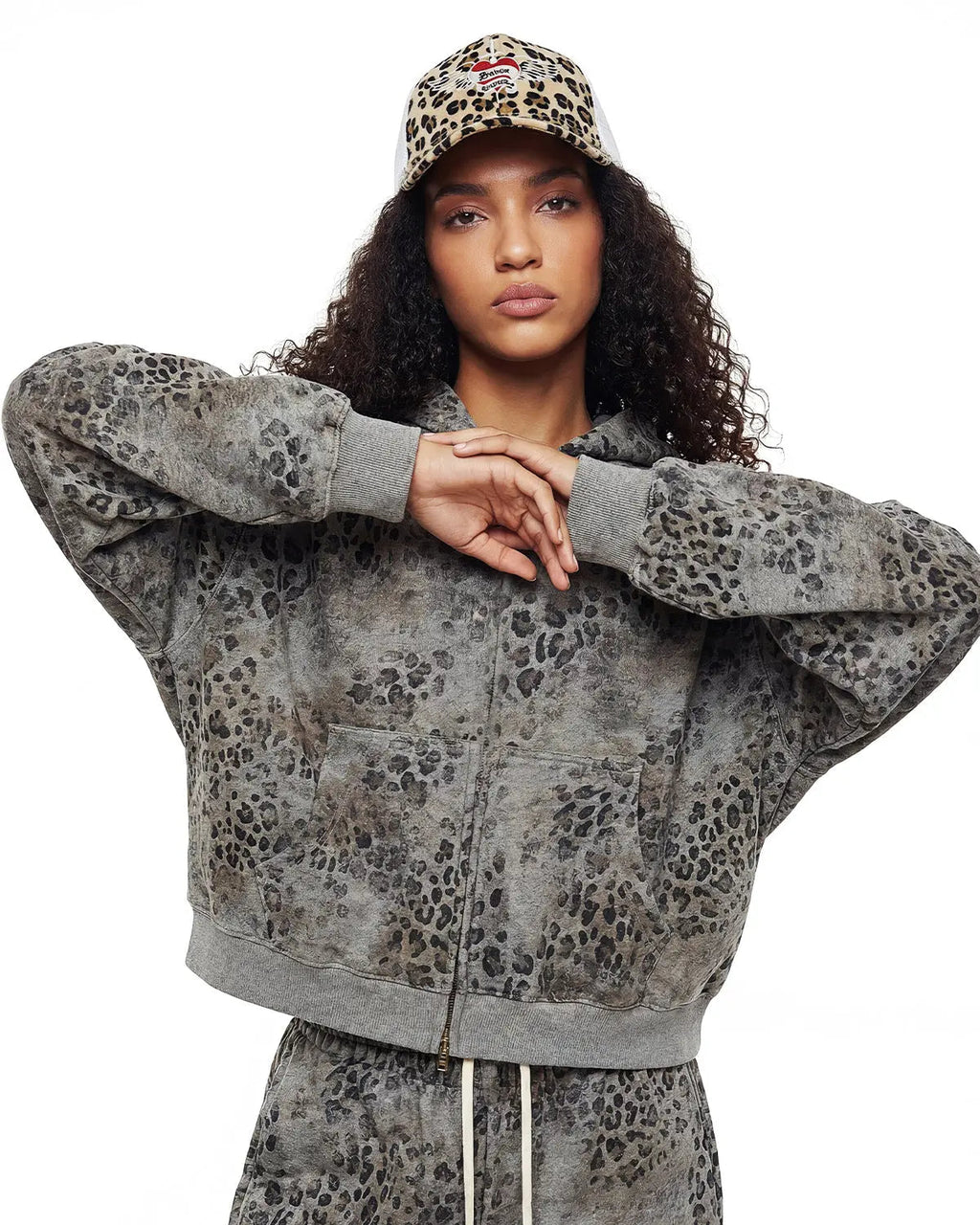 Leopard print boxy zip-up hoodie by INFLATION, featuring a casual streetwear style with a front zipper and bold animal pattern.