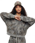 Leopard print boxy zip-up hoodie by INFLATION, featuring a casual streetwear style with a front zipper and bold animal pattern.