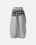 Inflation Streetwear plaid layered baggy sweatpants with relaxed fit and bold plaid pattern, displayed on a hanger.
