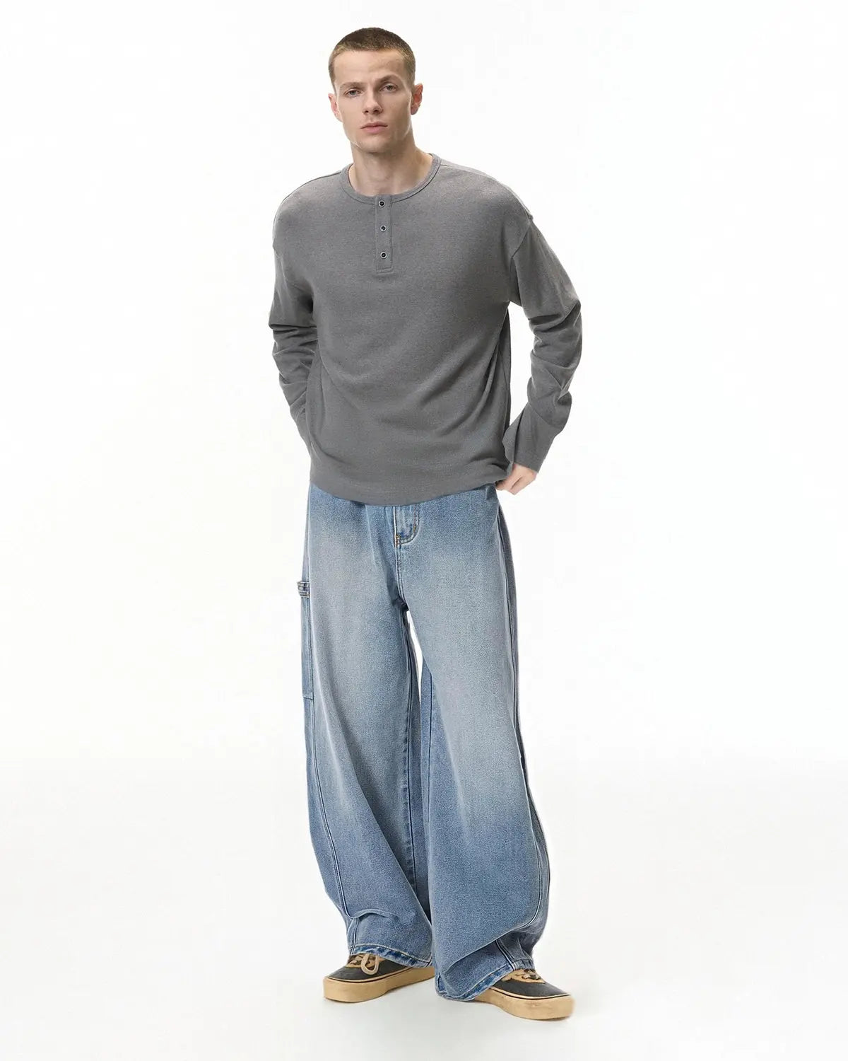 Distressed baggy cargo jeans by INFLATION with a relaxed fit, featuring ripped details and multiple cargo pockets.