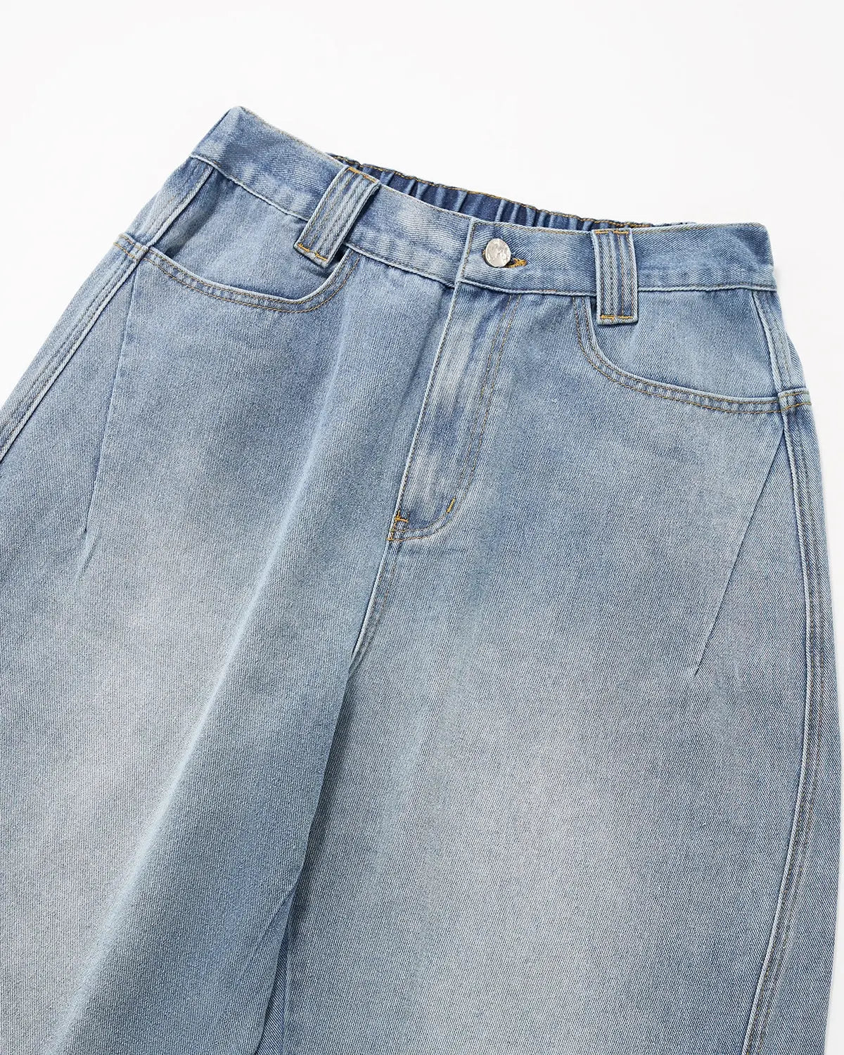 Distressed baggy cargo jeans by INFLATION featuring a relaxed fit, ripped details, and multiple cargo pockets for a streetwear look.