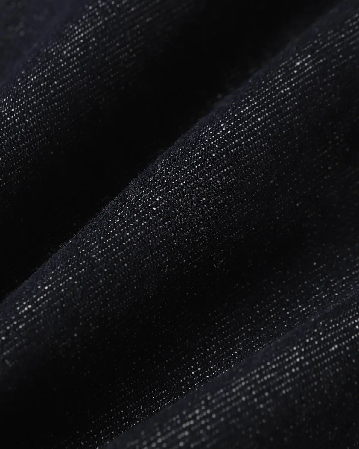 Deconstructed scimitar denim longline jorts by INFLATION, showing distressed details and long, loose fit on a casual pants style.