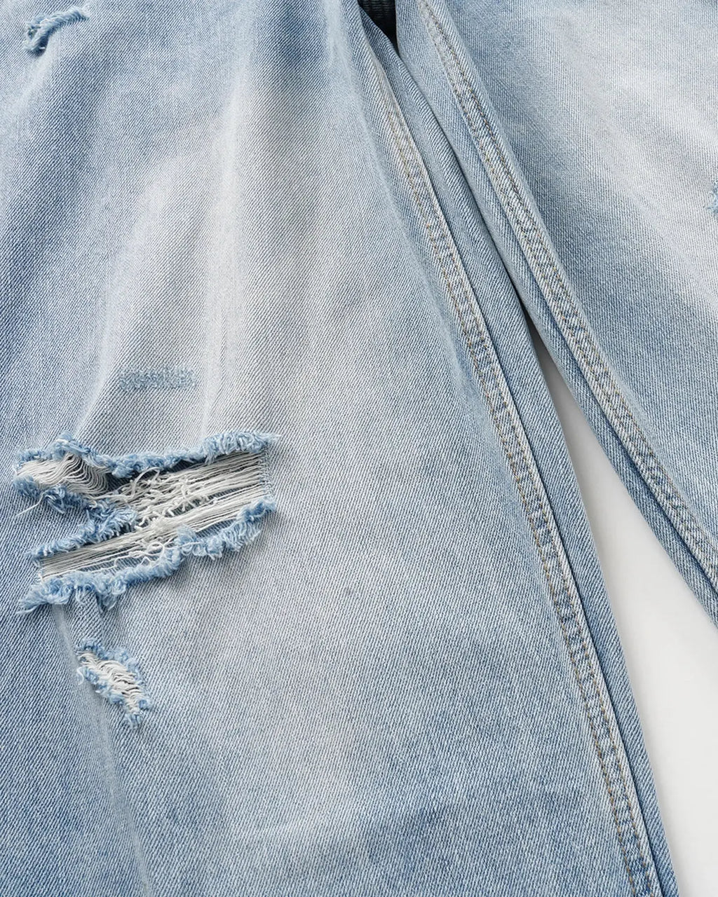 Inflation Double Waist Distressed Baggy Jeans showing ripped details, relaxed fit, and worn denim texture for streetwear style.