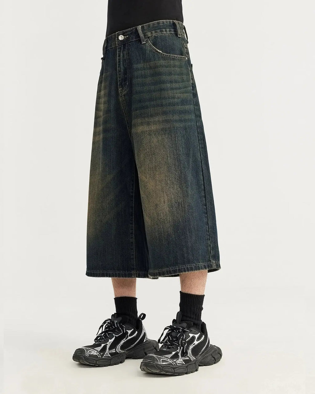 Acid washed longline baggy denim jorts by INFLATION, casual streetwear pants with a relaxed fit and distressed denim appearance.