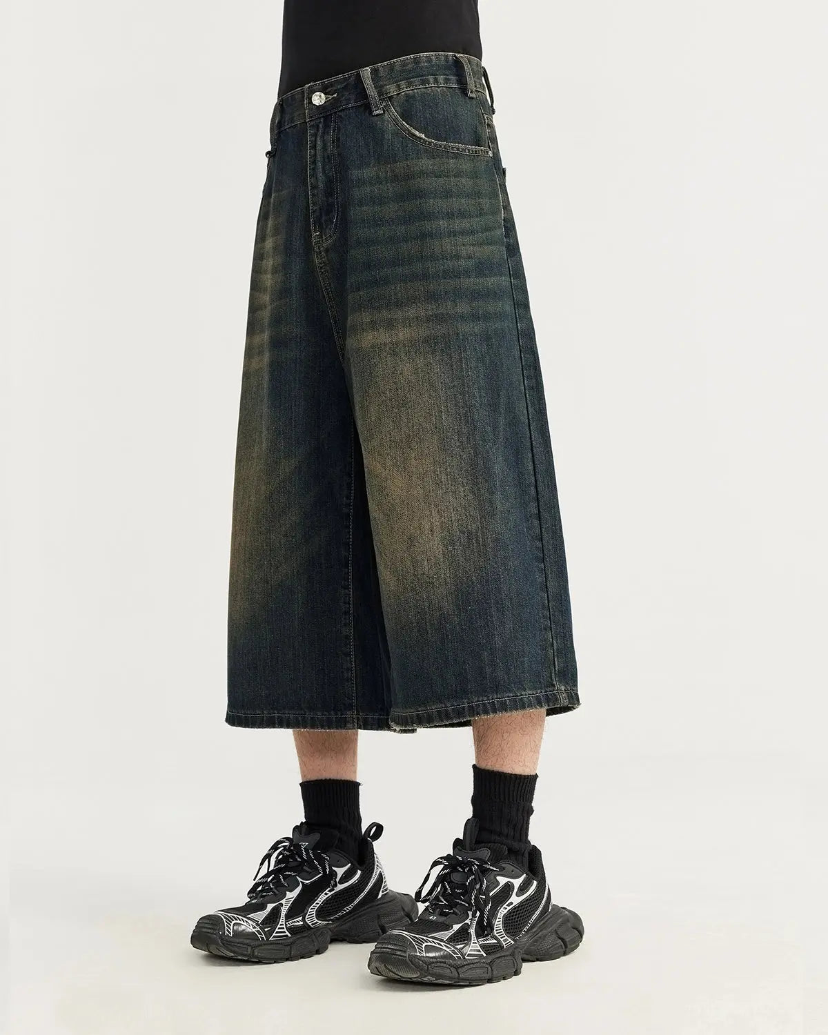 Acid washed longline baggy denim jorts by INFLATION, casual streetwear pants with a relaxed fit and distressed denim appearance.