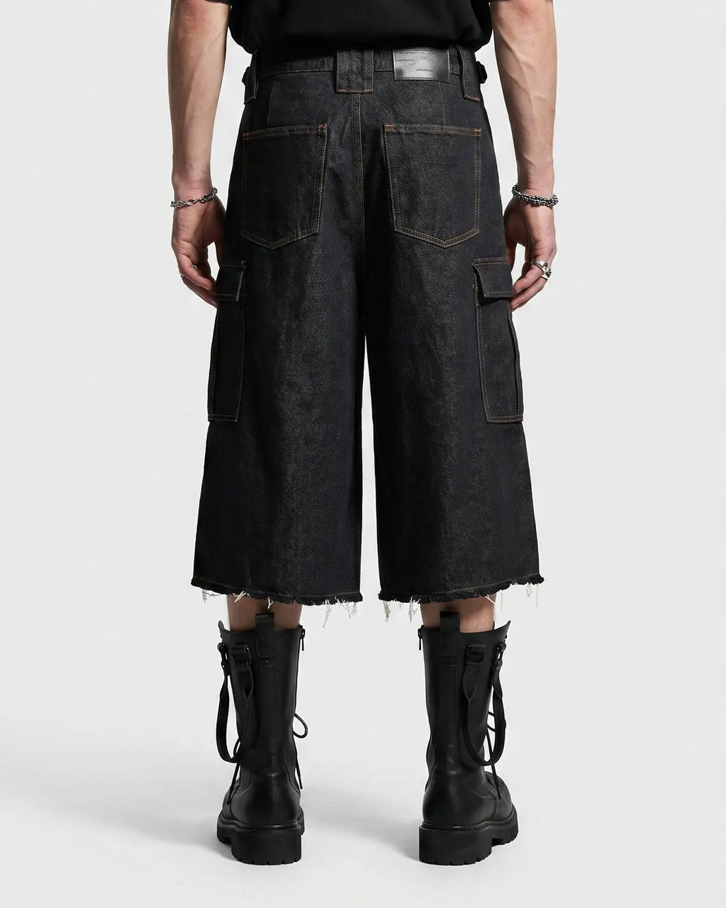 Layered utility baggy jorts pants by INFLATION featuring a loose fit, multiple pockets, and distressed denim style.
