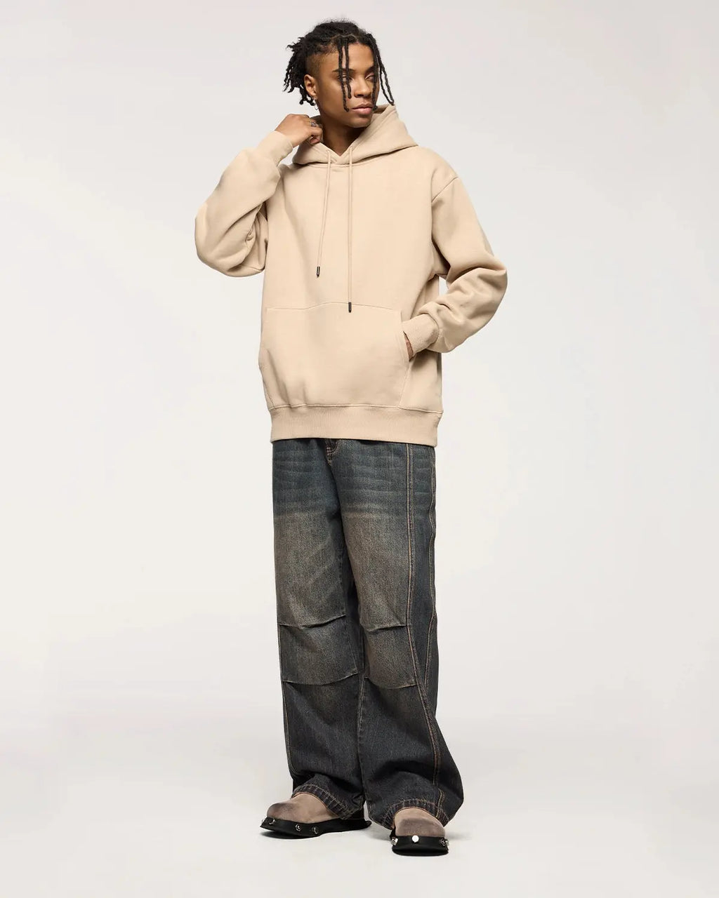 INFLATION faded dirty baggy cargo jeans with distressed details and relaxed fit, shown in a close-up front view.