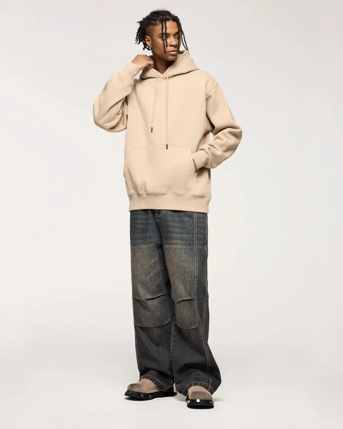 INFLATION faded dirty baggy cargo jeans with distressed details and relaxed fit, shown in a close-up front view.