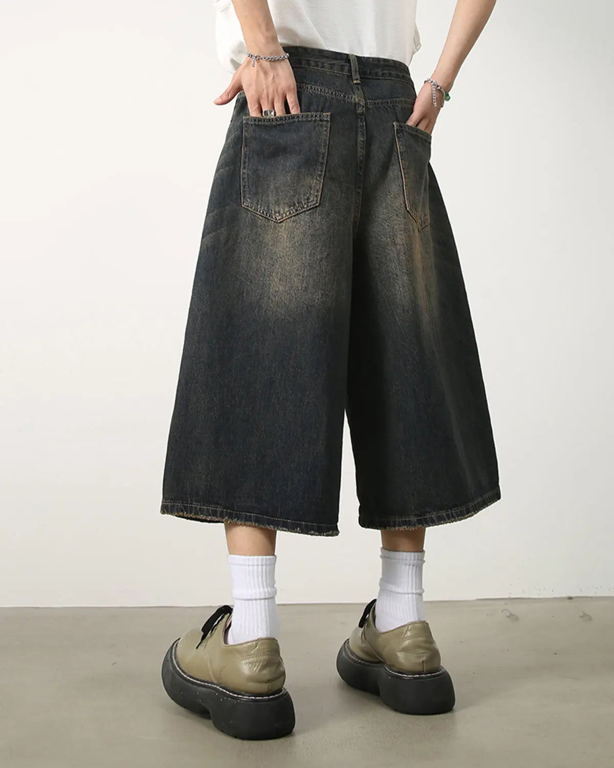 Washed baggy denim jorts by INFLATION, featuring a relaxed fit and distressed details, styled as streetwear casual shorts.