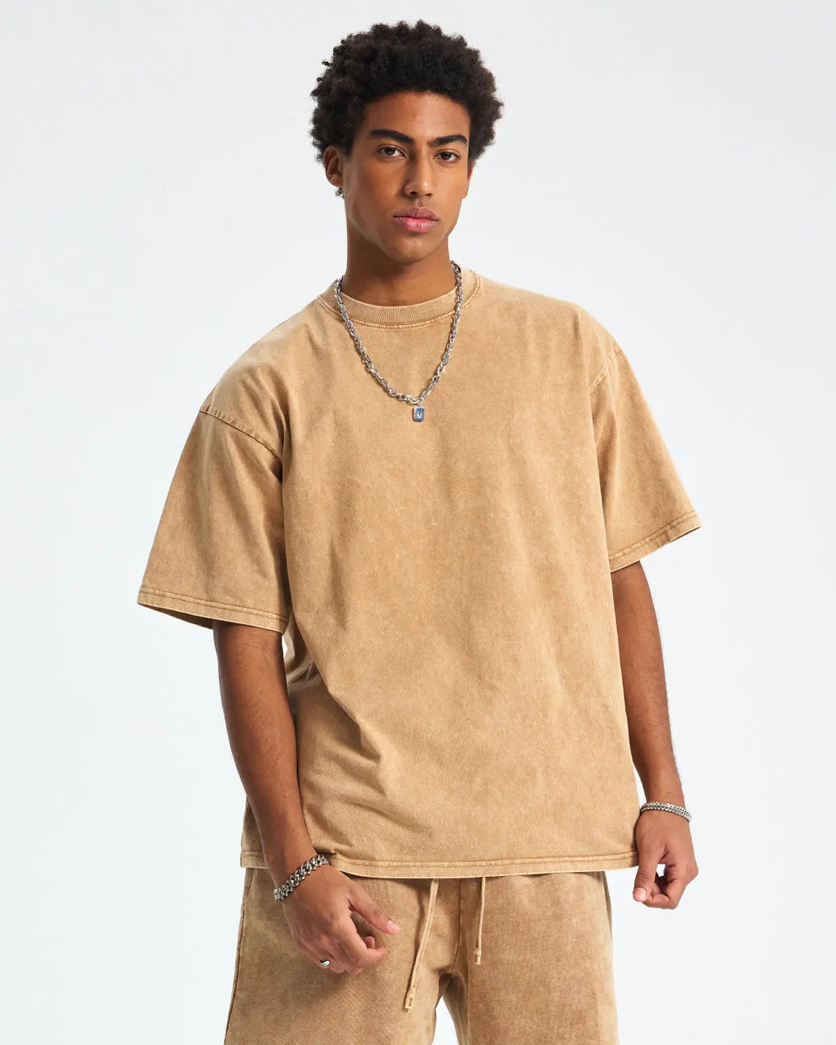 Snow Washed Oversized T-Shirt by INFLATION, featuring a relaxed fit and soft fabric, displayed on a hanger against a neutral background.
