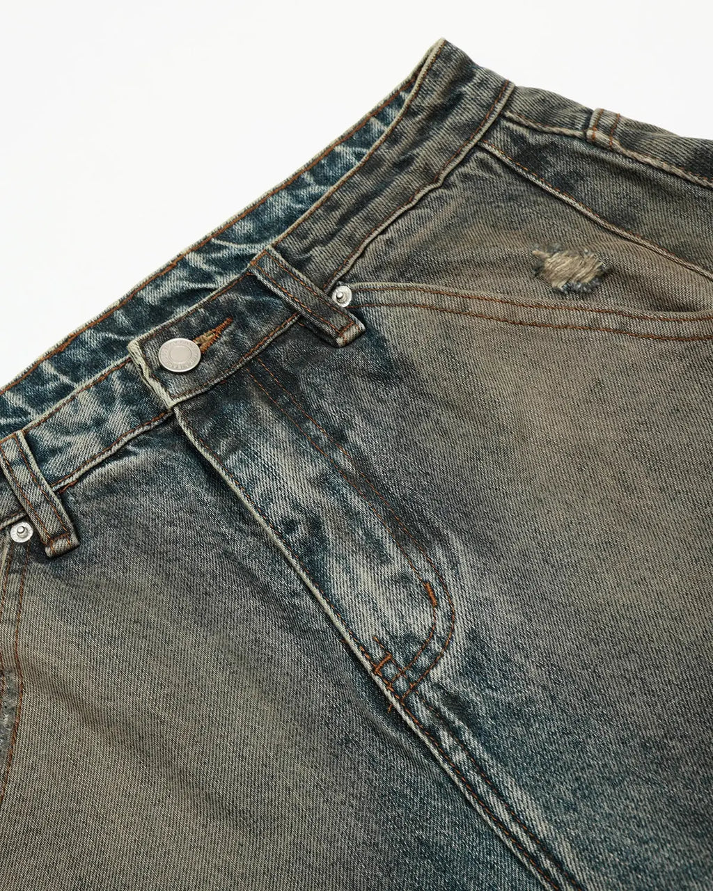 Distressed dirty wash barrel jeans by INFLATION, featuring a rugged, faded denim look with intentional wear and tear details.