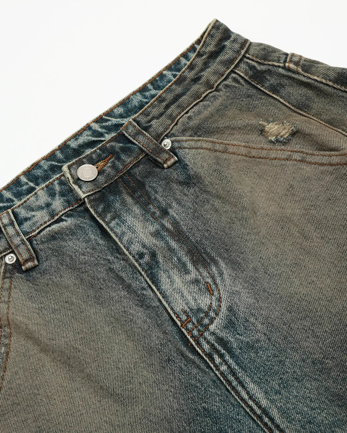 Distressed dirty wash barrel jeans by INFLATION, featuring a rugged, faded denim look with intentional wear and tear details.