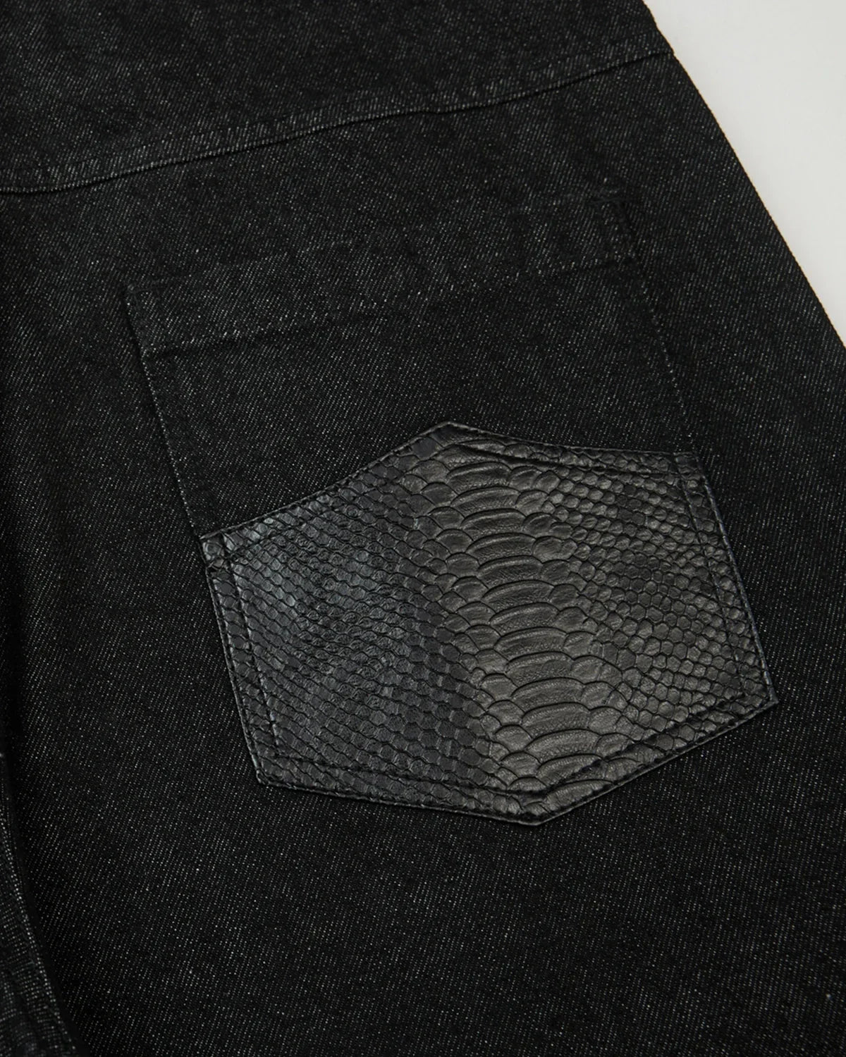Black baggy long jorts by INFLATION Streetwear, featuring loose fit denim with a relaxed, edgy style visible in the image.