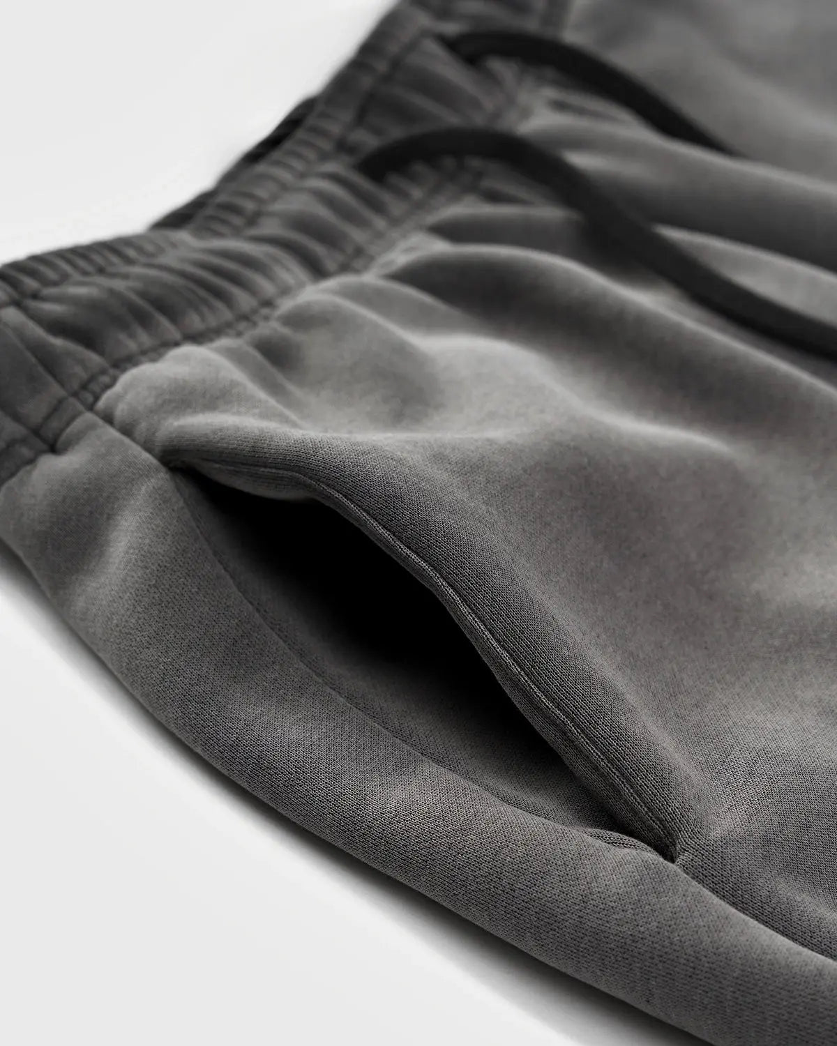 Acid washed INFLATION streetwear sweatpants with relaxed fit and casual style, shown on a model.