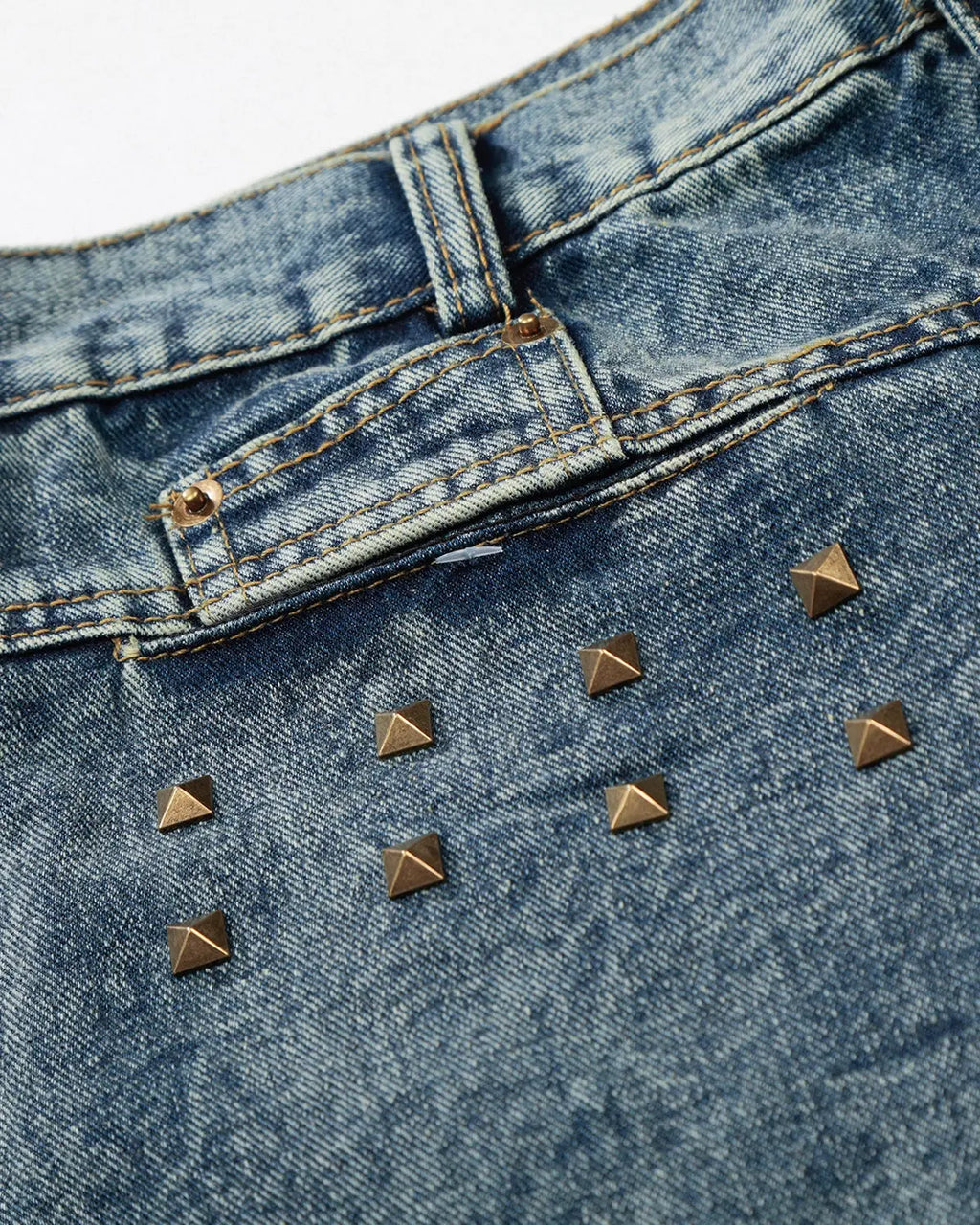 Inflation brand studded washed long baggy jorts, denim pants with metal stud details and a relaxed, oversized fit.