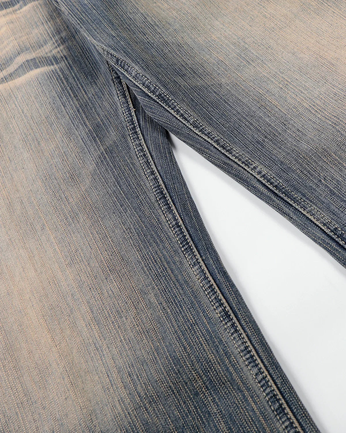 Bamboo weave dirty wash barrel jeans by INFLATION, featuring distressed denim and a relaxed fit, displayed on a white background.