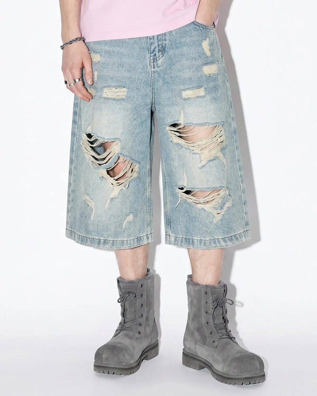 Distressed longline jorts pants by INFLATION, featuring a rugged, casual style with frayed edges and a relaxed fit.
