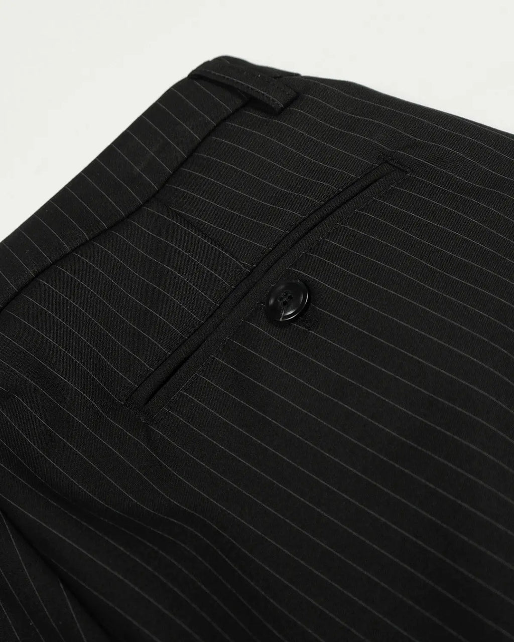 Black striped barrel suit pants by INFLATION Streetwear, featuring a relaxed fit and bold striped pattern, shown on a neutral background.