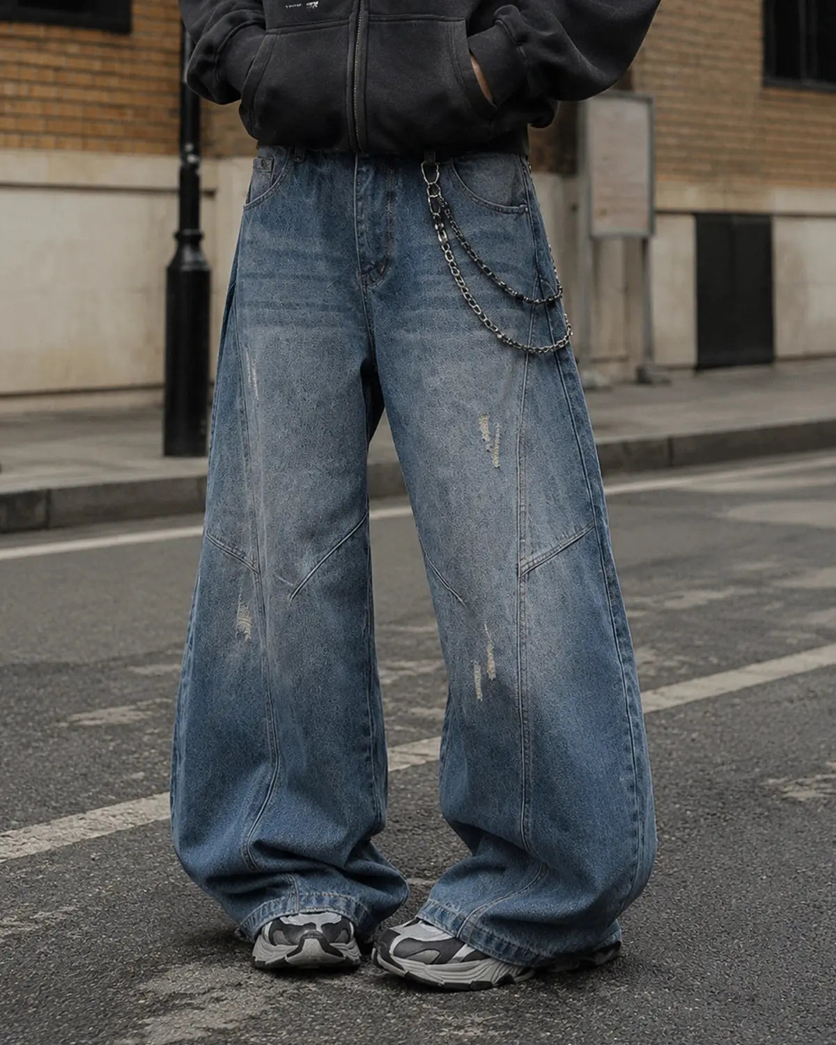 Distressed ripped baggy jeans by INFLATION Streetwear, showing a relaxed fit with frayed holes and faded denim details.