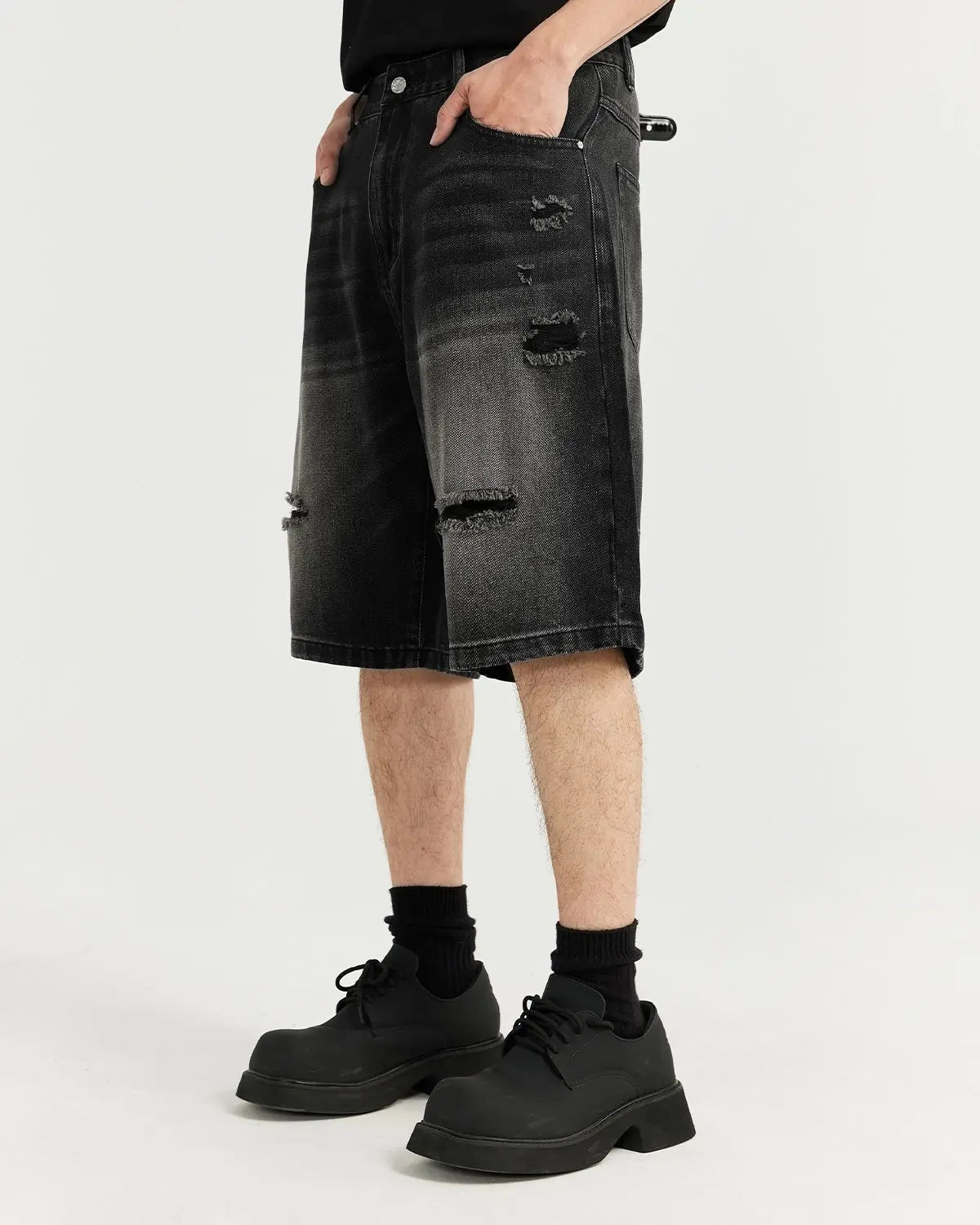 Vintage ripped washed jorts by INFLATION streetwear, showing distressed denim shorts with frayed edges and faded wash finish.