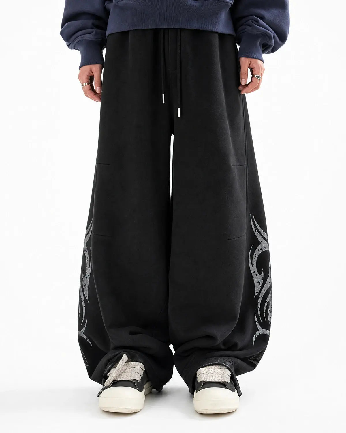 Washed distressed barrel sweatpants by INFLATION Streetwear featuring a relaxed fit with rips and fading details.